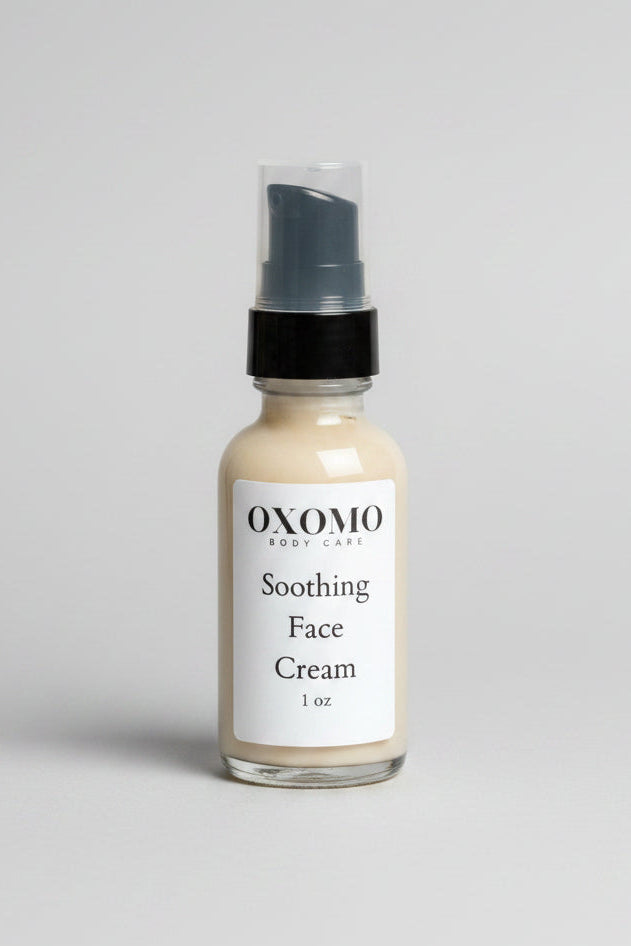 Bottle of OXOMO Soothing Face Cream on a textured surface